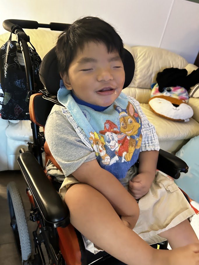 Arel smiling in his chair