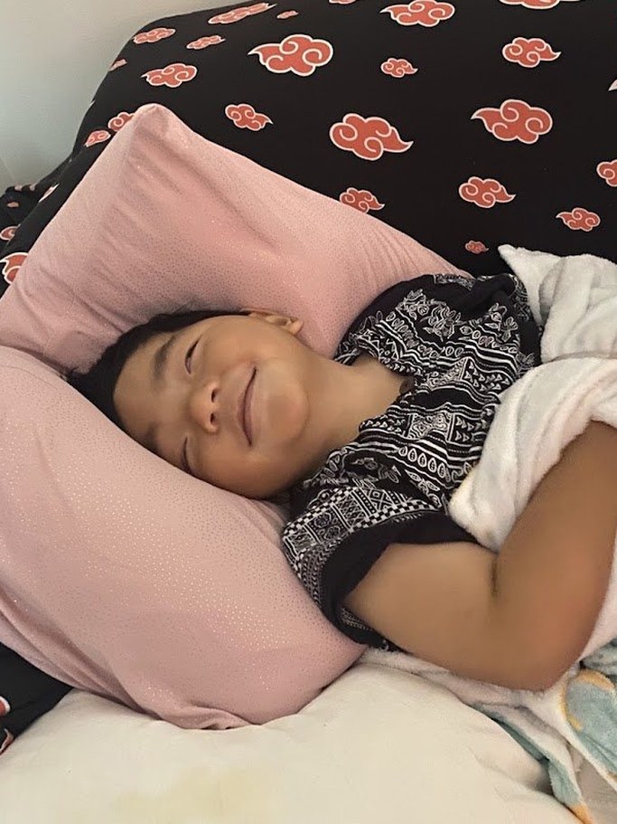 Arel smiling as he rests in bed